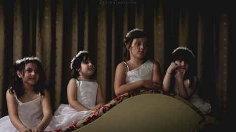 Photo of four little bridesmaids sitting reverse on a daybed