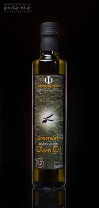 A glass bottle of extra virgin olive oil, photographed in dark background