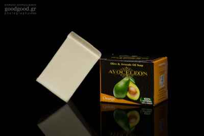 Product photograph of a bar of soap made of olive and avocado oil in dark background
